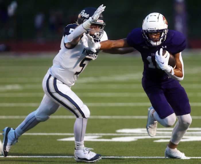 Charlie Becker of Father Ryan attempts to dodge a tackle by Jaxon Hayes of Pope John Paul II during their game Friday, Sep 2, 2022.